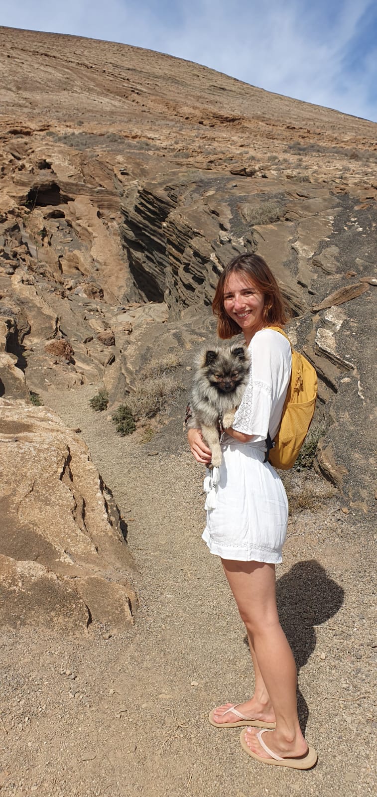 Hiking in nature with a small fluffy dog